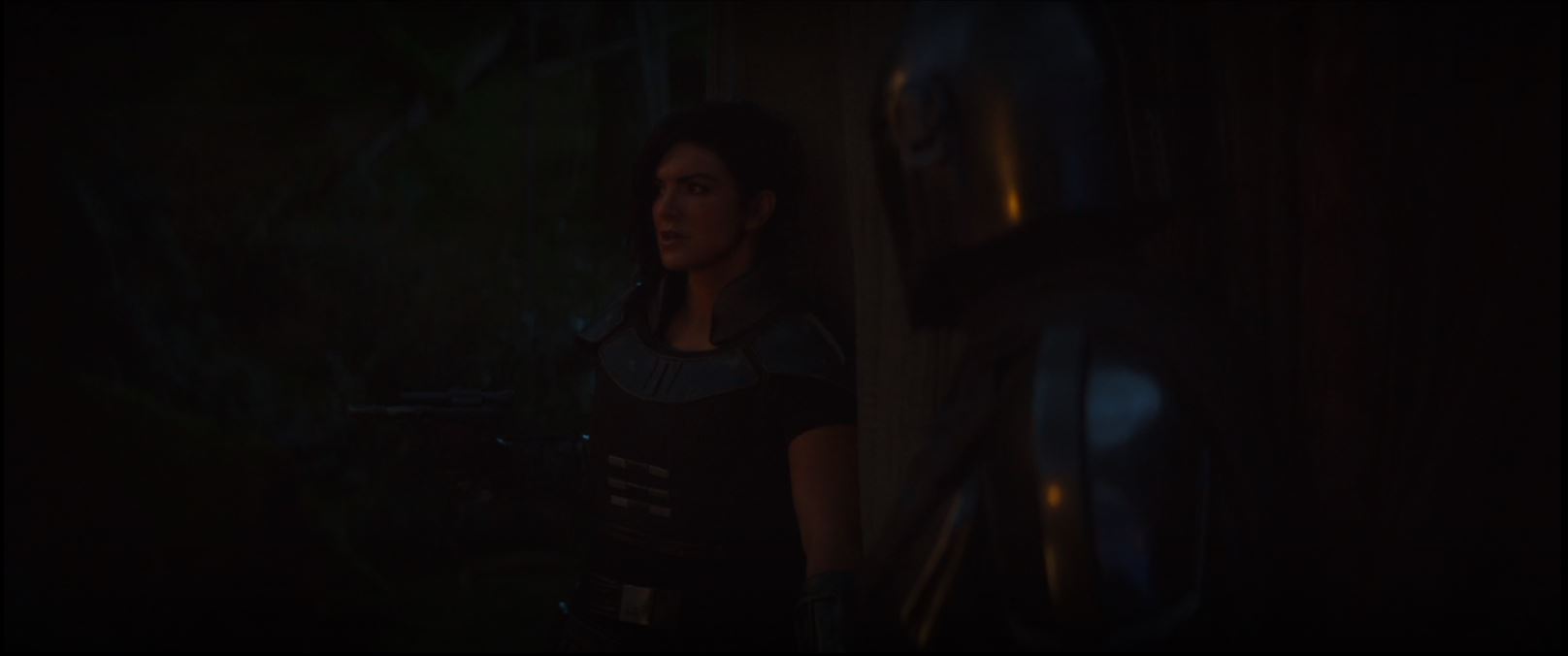 Cara Dune holds her pistol ready when she and The Mandalorian are about to enter one of the tents of the Klatoonian camp in "Chapter 4: Sanctuary"