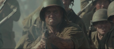 Milo Gibson fires an M1A1 Thompson as Lucky Ford in Hacksaw Ridge (2016).