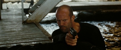 Jason Statham holds a Glock 17 as Arthur Bishop in The Mechanic (2011.