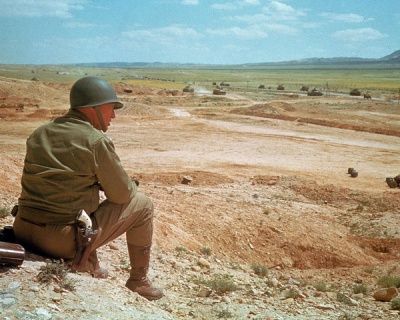 General Patton observing his troops in the Spring of 1943 in Tunisia. Notice the famous Colt SAA in holster. Photo was taken by Life photographer Eliot Elisofon (1911-1973).