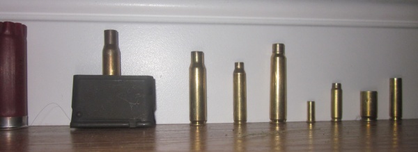 The brass of all the cartridges my JROTC classmates fired from left to right: 12 Gauge, .30 Caliber/.30-60 Springfield, .308 Winchester/ 7.62x51mm NATO, .223 Remington, 7.7x58 Arisaka, .22 Long Rifle, FN 5.7x25mm?, .45 ACP, and some unidentifiable cartridge.