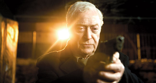 Michael Caine as Harry Brown holding a SIG-Sauer P226R in a publicity still.
