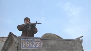 Grady (Christopher Gartin) fires a Colt Commando from the truck.