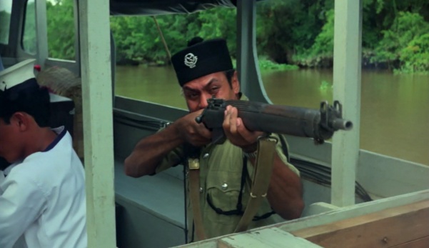 Sgt. Jamil firing his Lee-Enfield No.4 Mk 1* rifle from the boat during communist ambush in prologue.