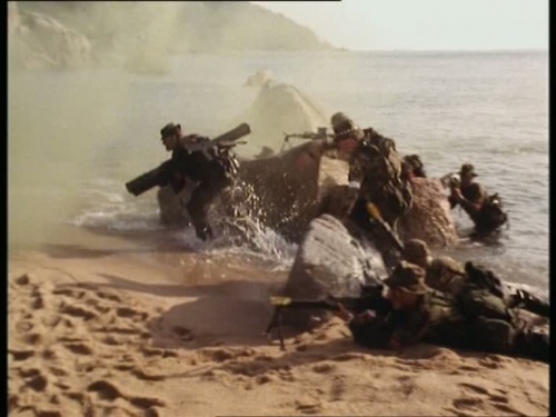 A soldier moves forward carrying an extended LAW 80 during a beach assault in "The Last Post" (Season 5, Episode 7).