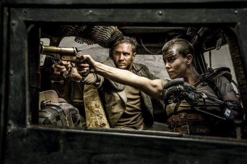 A production photo from "Mad Max: Fury Road", depicting Furiosa (Charlize Theron) with a Webley No.1 Mk III* flare gun and Max (Tom Hardy) with a P08 Luger pistol.